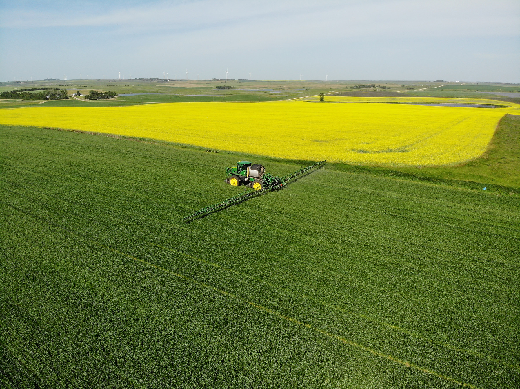 A large combine type tractor spraying a field